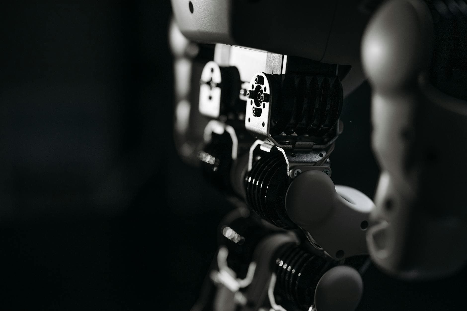 Detailed close-up of a robot's mechanical components, emphasized by moody studio lighting.